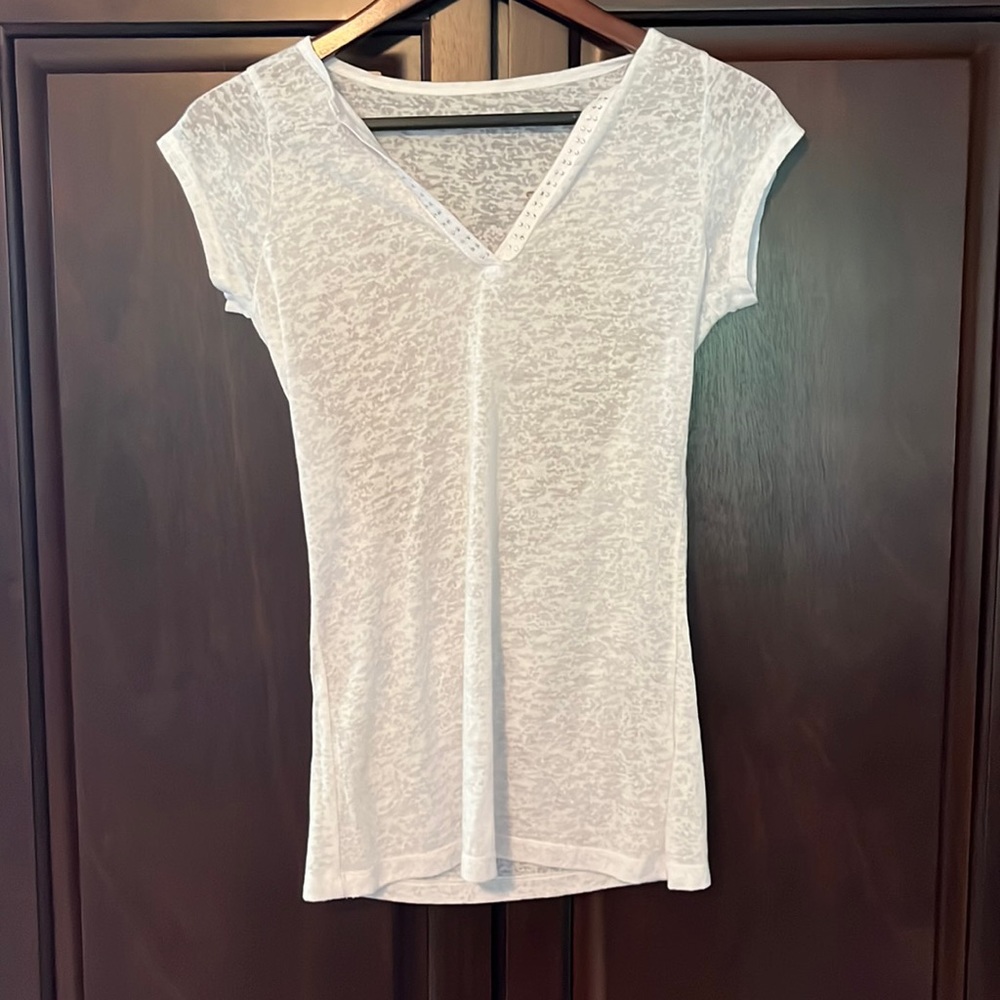 White transparent t-shirt with gold and silver sparkle wings on the back